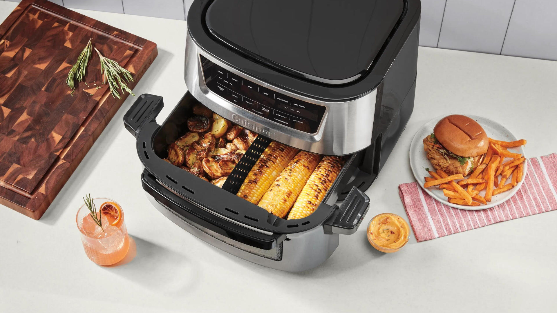 Basket Air Fryer with corn inside and burger and fries on the side